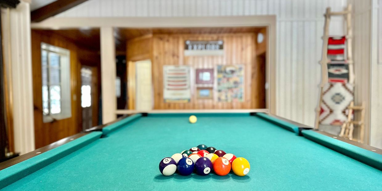 Get ready for a game of pool while others head out to the hot tub through the door in the distance.