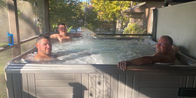 Two generations relaxing in the hot tub at The Cabin.