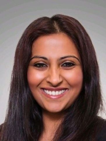 Smiling woman with long dark hair.