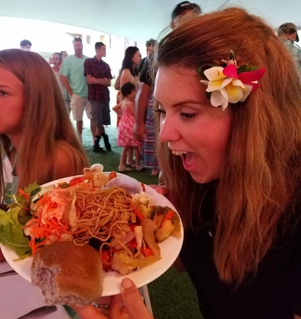 girl showing off her luau feast