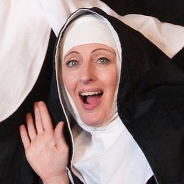 Promotional photo for theatrical production of "Nunsense" featuring a tower of nuns in various poses