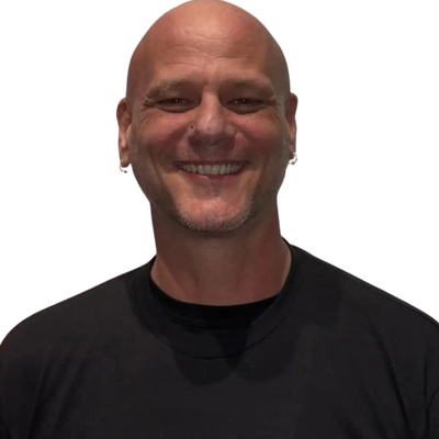 Smiling bald man wearing a black t-shirt.