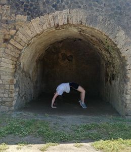 Wheel in the arch of the arena in Pompeii.