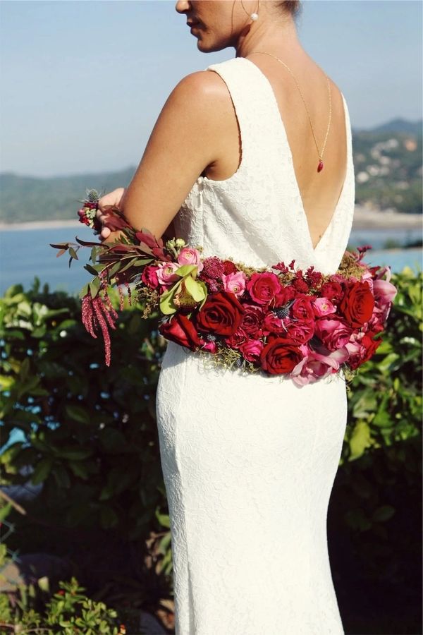 Fresh floral shrug. Rich red and pink tones. Modern way to incorporate flowers into your bridal styl