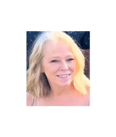 Smiling woman with blonde hair in natural light.