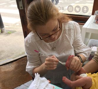 Taking baby prints on pottery at Craftsea Paint Your Own Pottery Studio in Mumbles Swansea