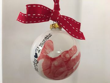 Bespoke hand print Christmas bauble made at Craftsea Paint Your Own Pottery Studio