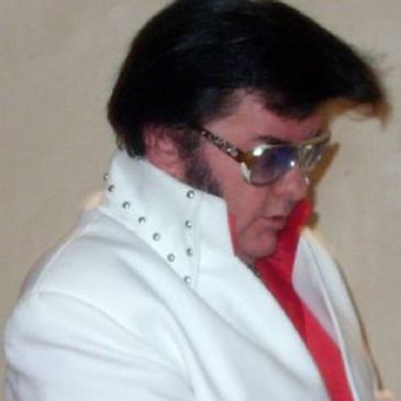 Person in white studded jacket and sunglasses.