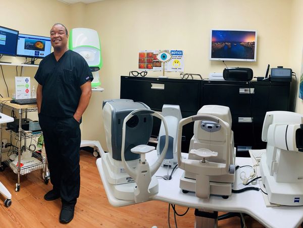 Office manager, Mr Kelvin Adams, standing inside King Vision’s screening room.  Eye doctor near me