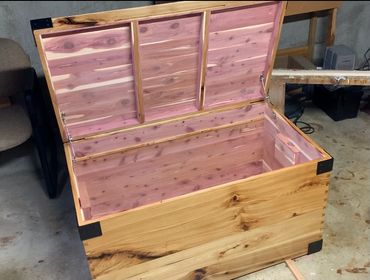 Cedar interior of a hickory chest with dovetails and metal brackets.