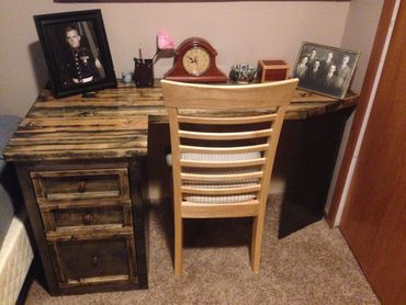 Antique desk with portraits and chair.