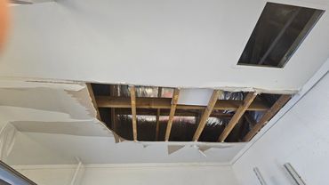 Restored ceiling with a large water-damage hole, expertly repaired at a fraction of the cost