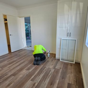 Fresh hybrid flooring installed—a durable, stylish upgrade for this bedroom