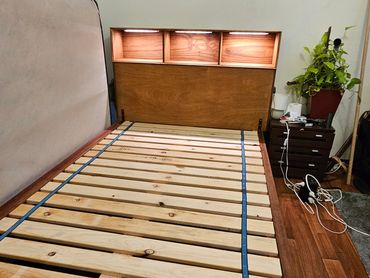 Custom-built queen-size bed frame crafted from solid merbau, jarrah, and pine, with LED lights.