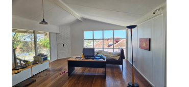 Transformed bedroom—fresh paint and bright windows breathe new life into this spacious, open retreat