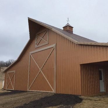 Diamond Bi-Fold door on a nice barn that's brown