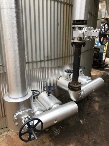 Industrial pipes with valves inside a facility.