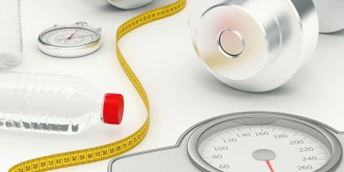 Fitness items including a dumbbell, weighing scale, water bottle, and measuring tape.