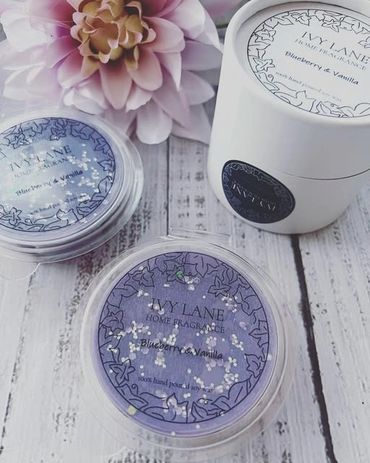 Blueberry & vanilla scented home fragrance products with floral decoration.