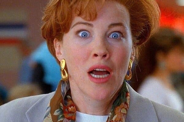 Shocked woman with wide blue eyes and open mouth.