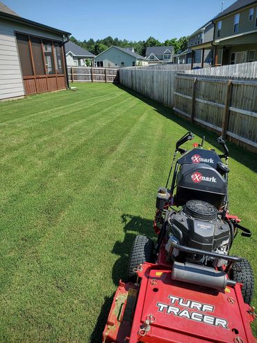 Georgia Lawn Pro mowing bermuda grass in Cartersville, GA with eXmark Turf Tracer.