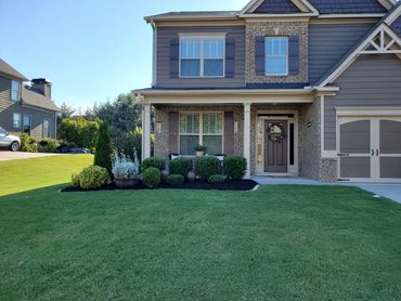 Georgia Lawn Pro mowing bermuda grass and maintaining flower beds in Cartersville, GA