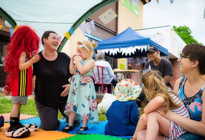 a creative practitioner at an arts festival playing with children