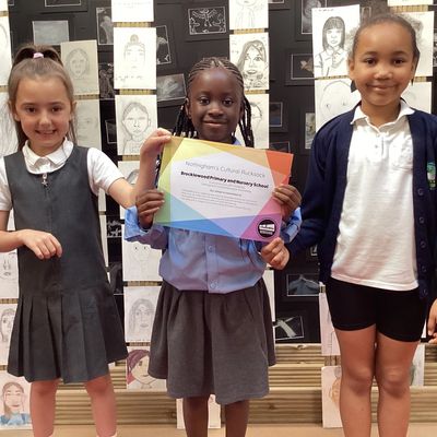 three children with a certificate