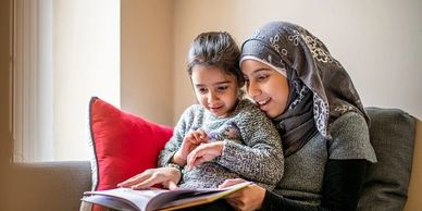 a mother and child read a book