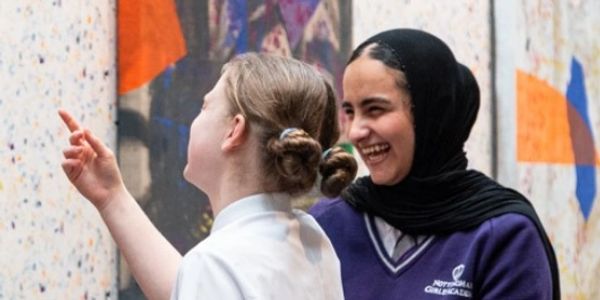 two schoolgirls laughing
