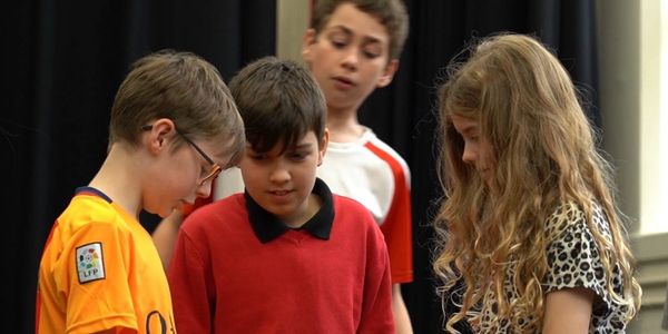 three young actors bow their heads