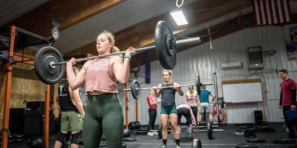 Woman holding a barbell in a CrossFit competition