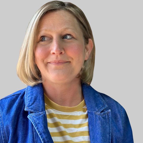 white woman in yellow and white top looks to the left. executive leadership coaching. coaching