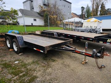 high capacity steel deck trailer used for moving forklifts and large machines. 