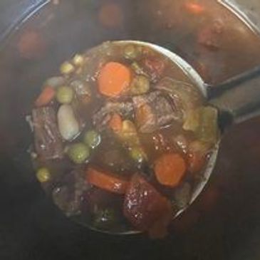 A spoonful of hearty pit beef vegetable soup.