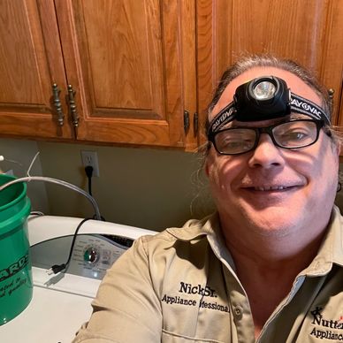 Nick the washer repairman is working on a washing machine in Gardner, KS dripping water into the tub