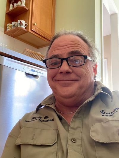 Nick the appliance repairman sitting down on the job again at Nutterman's Appliance Repair Service.