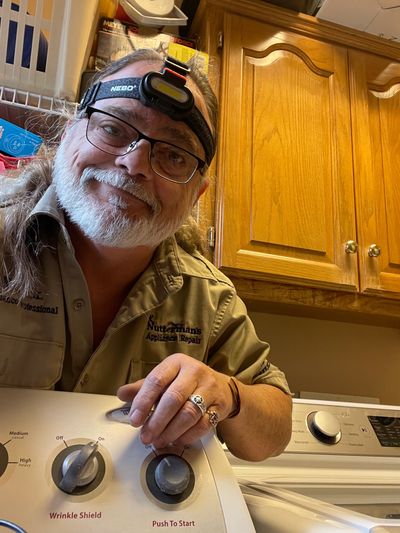 Nick the smiling appliance repairman behind a Maytag dryer with no heat in Overland Park, KS
