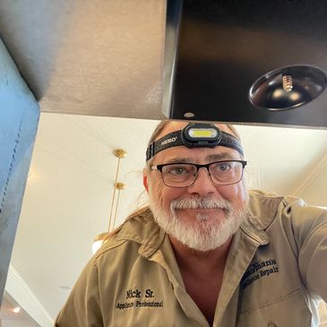 Nick from Nutterman's Appliance Repair Service looking under glass cooktop repair in Shawnee, KS