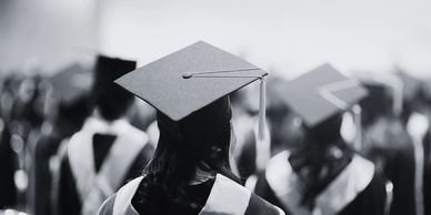 Black and white image of graduates in caps and gowns