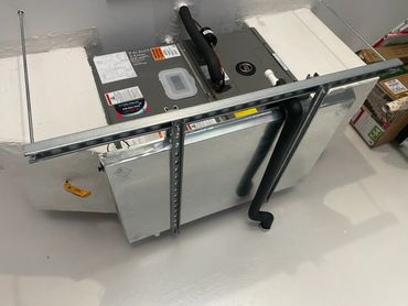 Ruud brand AC SYSTEM HANGING IN GARAGE,