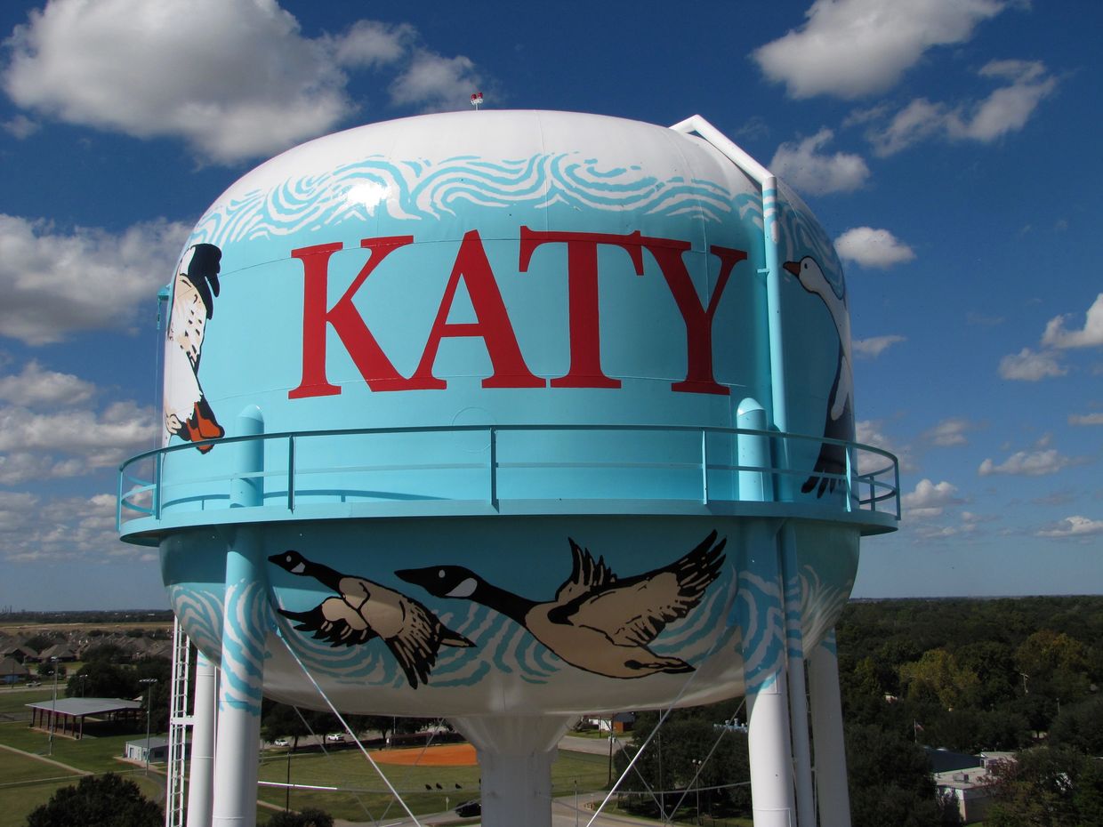 Water tower in Katy Tx with bird paintings and large letters.