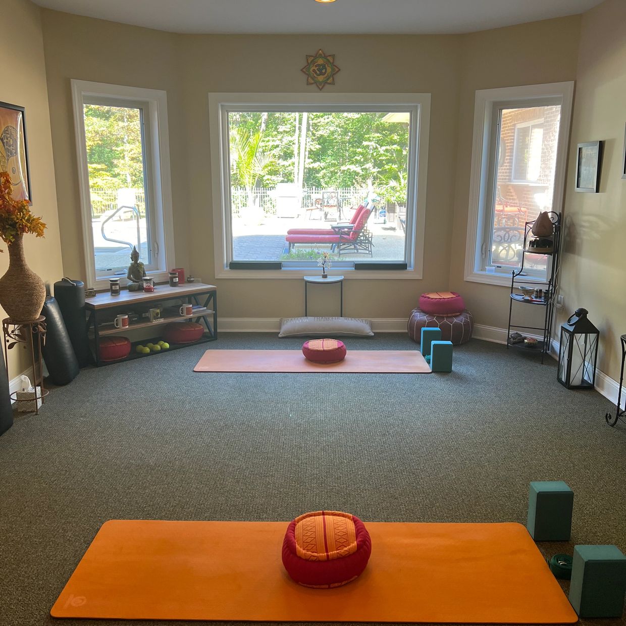 Calm yoga room with mats and cushions.