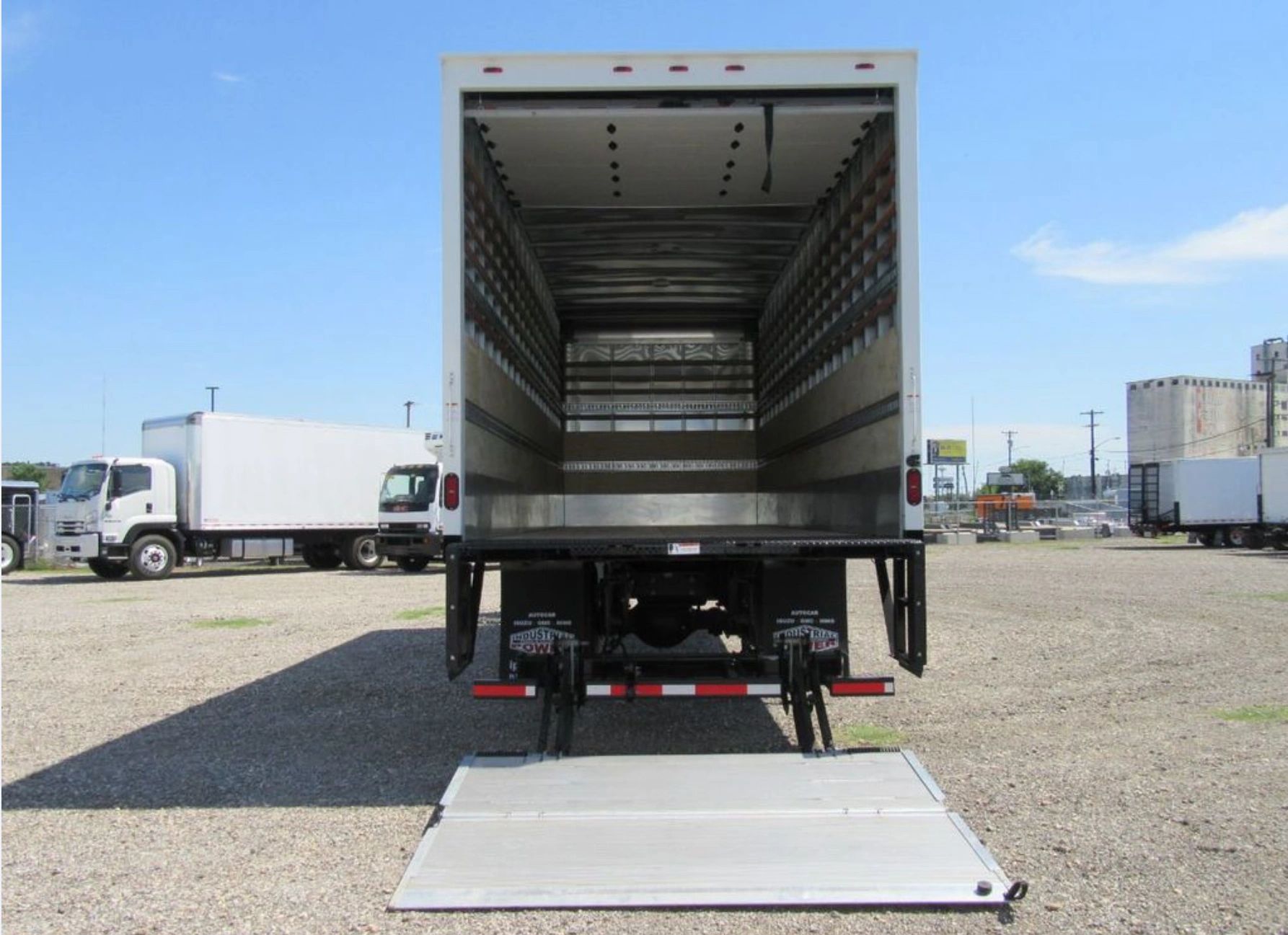 Image Description: A box truck with a liftgate, featuring a large cargo area with a rear Liftgate