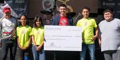 Brett deLeuze and teens during the check presentation at Crush Challenge.