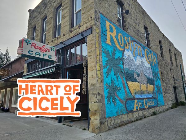 Exterior view of Roslyn Cafe with mural and retro sign.
