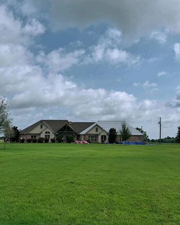 A house that is in the process of having a new roof put on it.