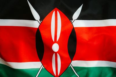 Close-up of the Kenyan flag with its distinctive shield and spears.