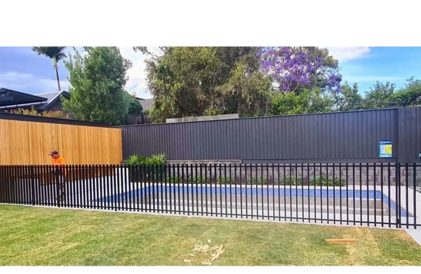 Pool with black aluminium barr style fence.