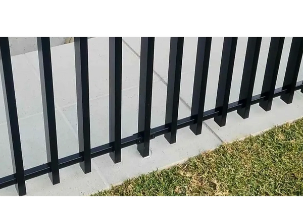 Close up of aluminium barr style fence with coloured coded grout instead of dress ring.